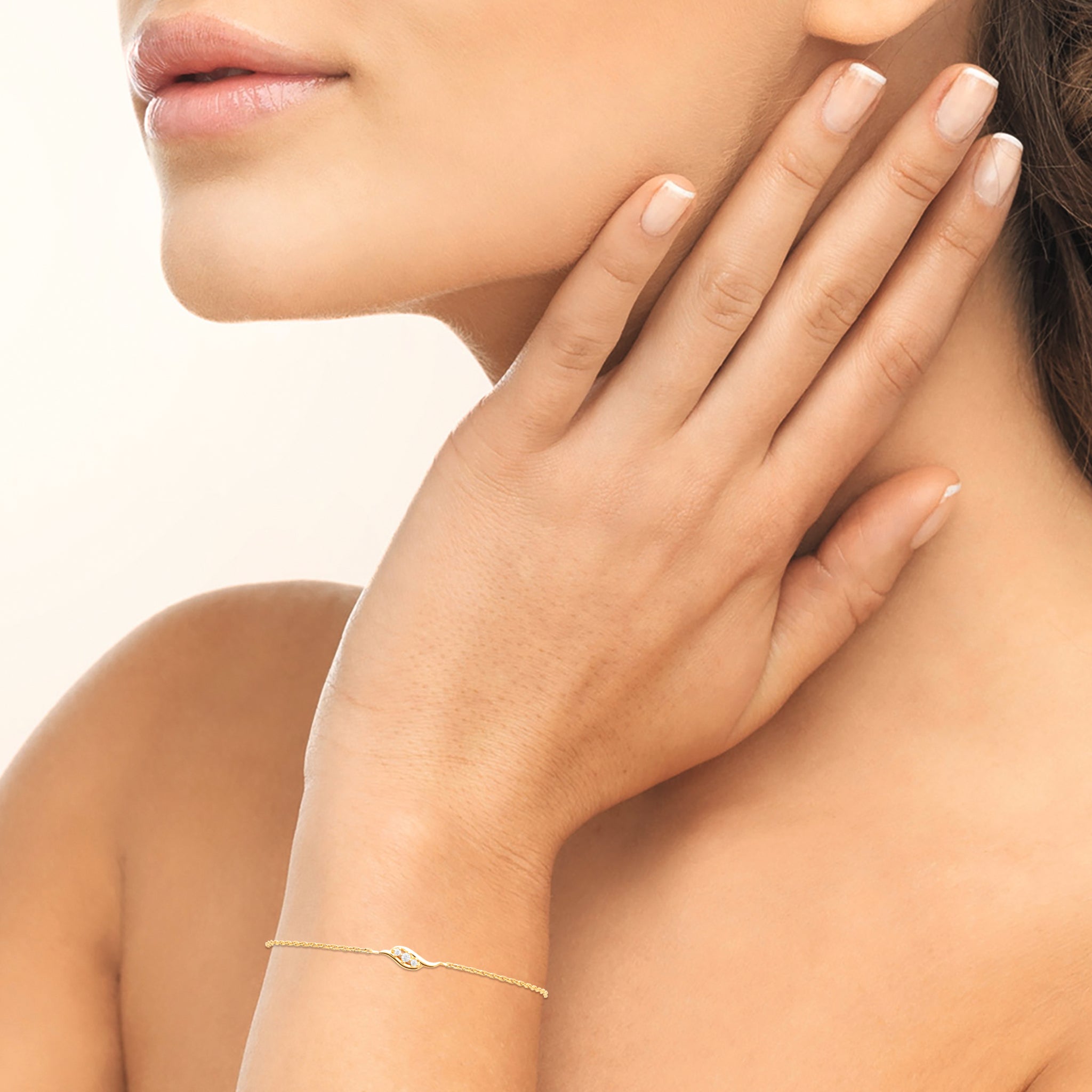 Bracelet en plaqué or avec trois oxydes blancs en forme de vague